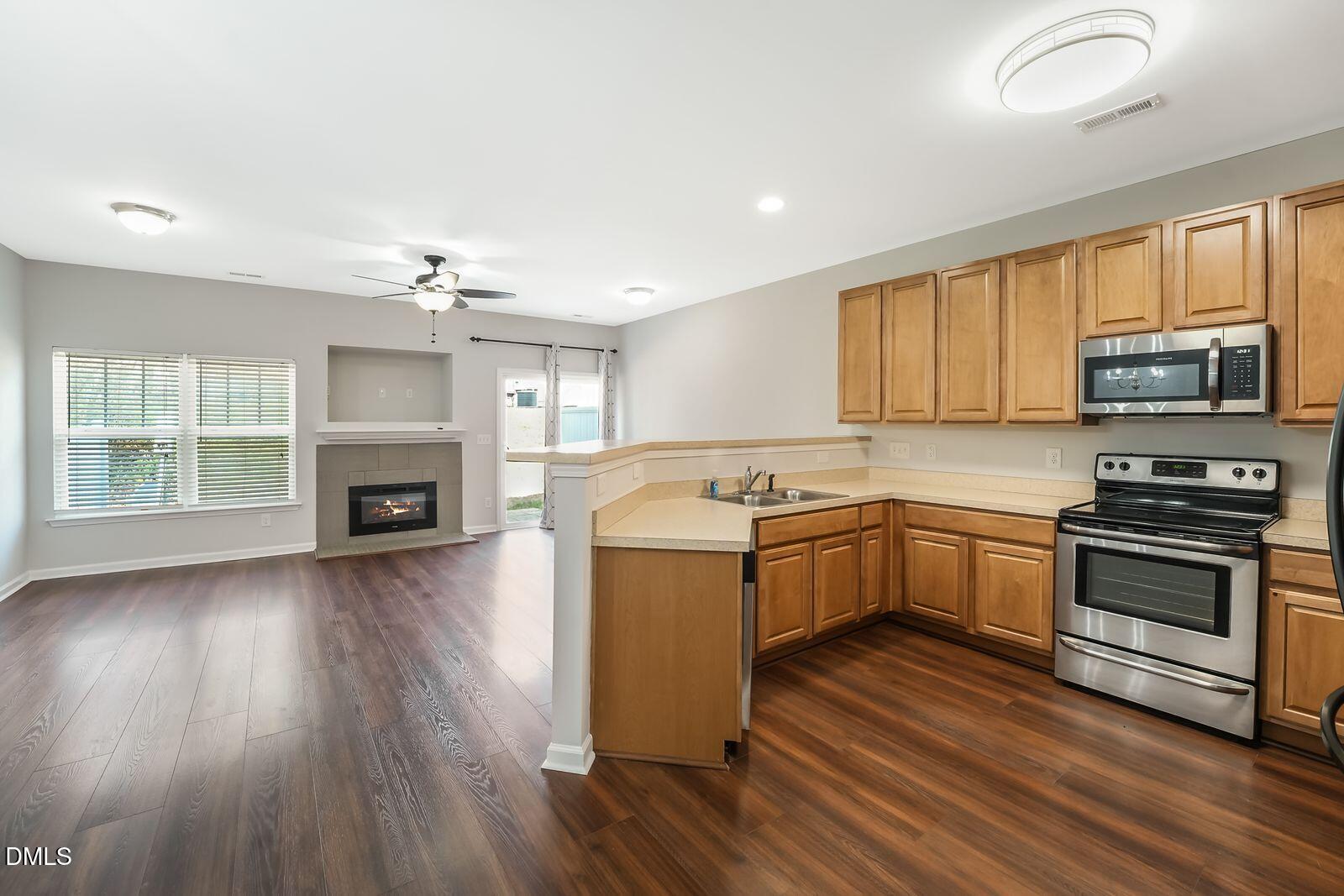 4909 Blue Rock Court Raleigh, NC 27610 - Photo 6 of 15 a kitchen with wooden floors and a stove top oven