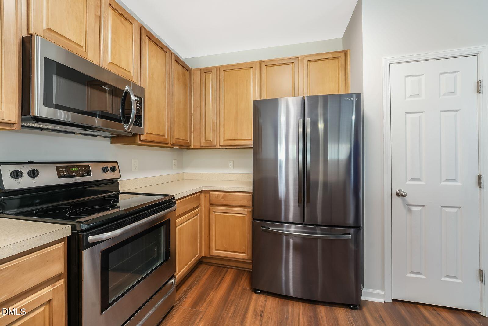 4909 Blue Rock Court Raleigh, NC 27610 - Photo 9 of 15 a kitchen with a refrigerator stove and microwave