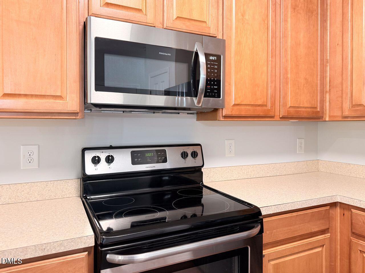 4909 Blue Rock Court Raleigh, NC 27610 - Photo 10 of 15 a kitchen with a stove and a microwave