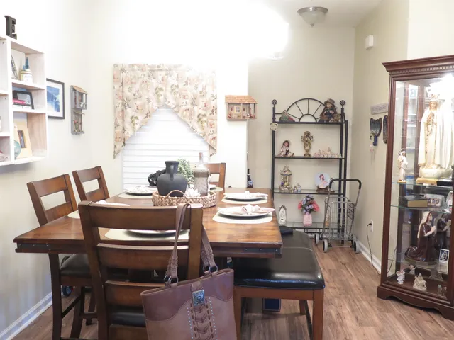 a view of a dining room with furniture and wooden floor