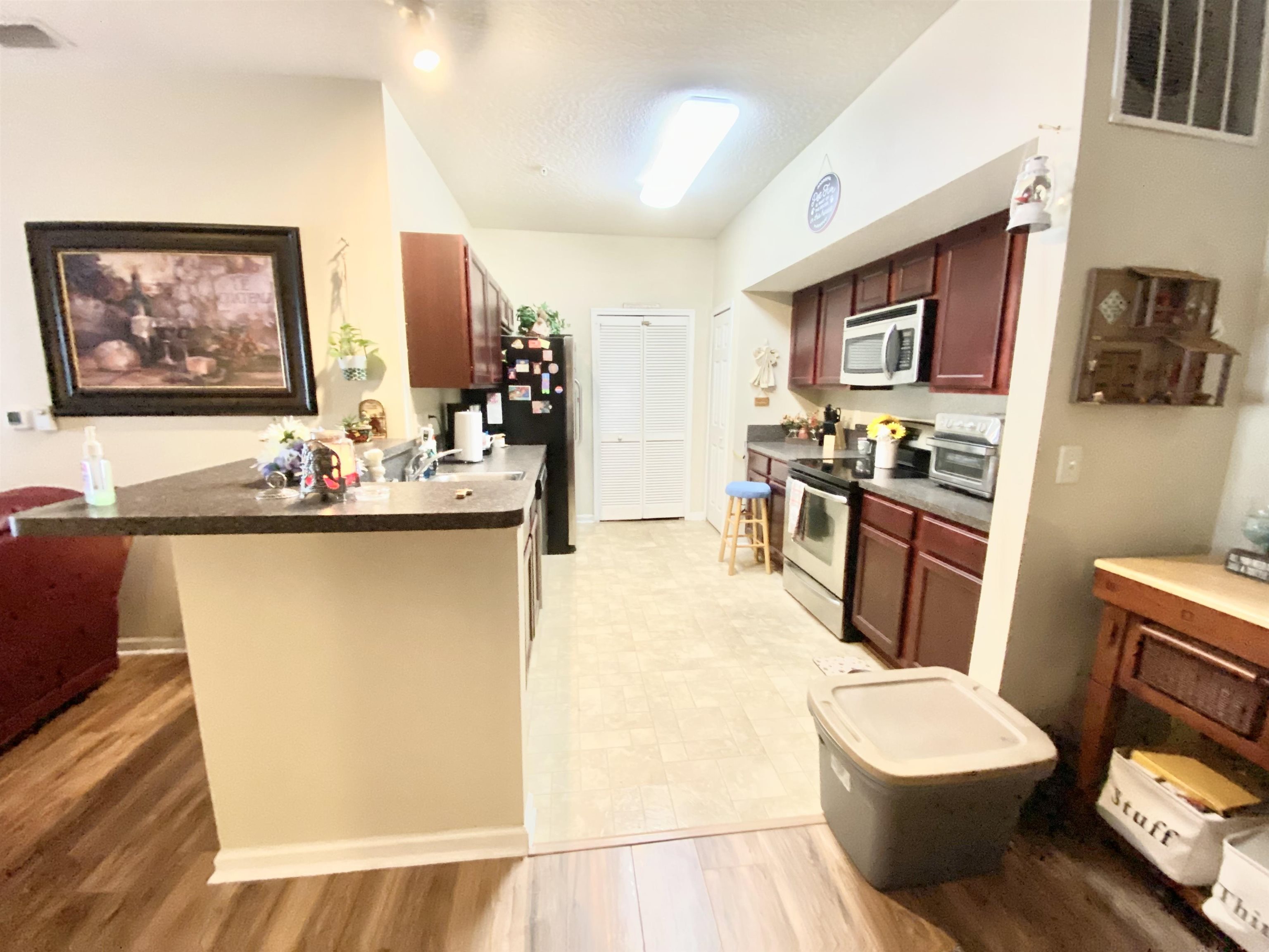 2534 Golden Lake Loop St. Augustine, FL 32084 - Photo 12 of 16 a living room with stainless steel appliances furniture a flat screen tv and a refrigerator