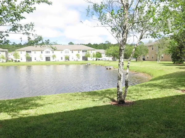 a view of a lake with houses in the background