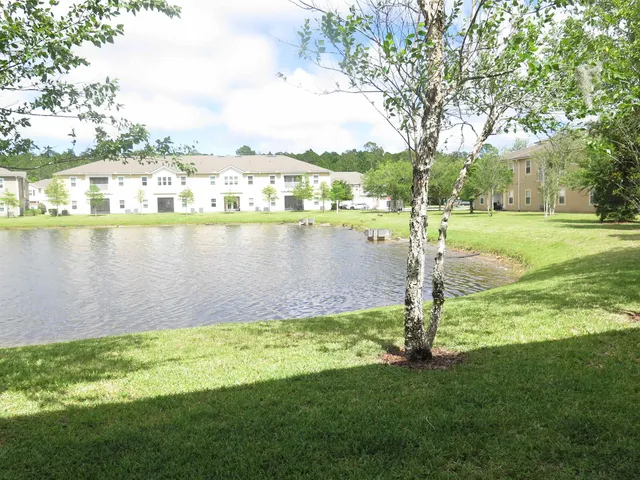 a view of a lake with houses in the background