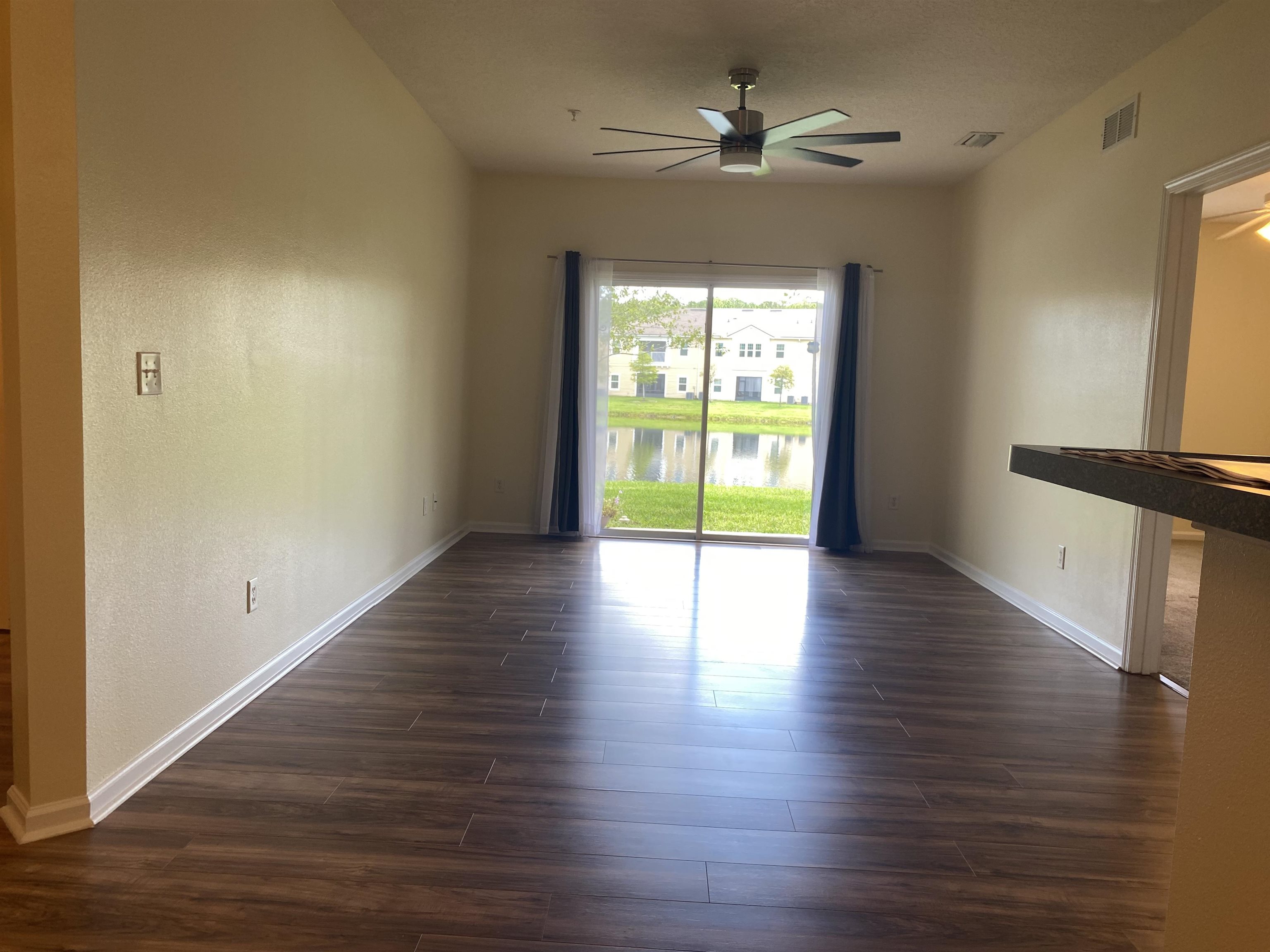 2534 Golden Lake Loop St. Augustine, FL 32084 - Photo 8 of 16 a view of an empty room with wooden floor and a window