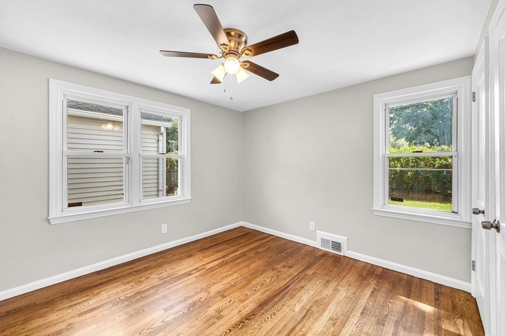 20 Drexel Street Springfield, MA 01104 - Photo 17 of 32 an empty room with wooden floor and windows