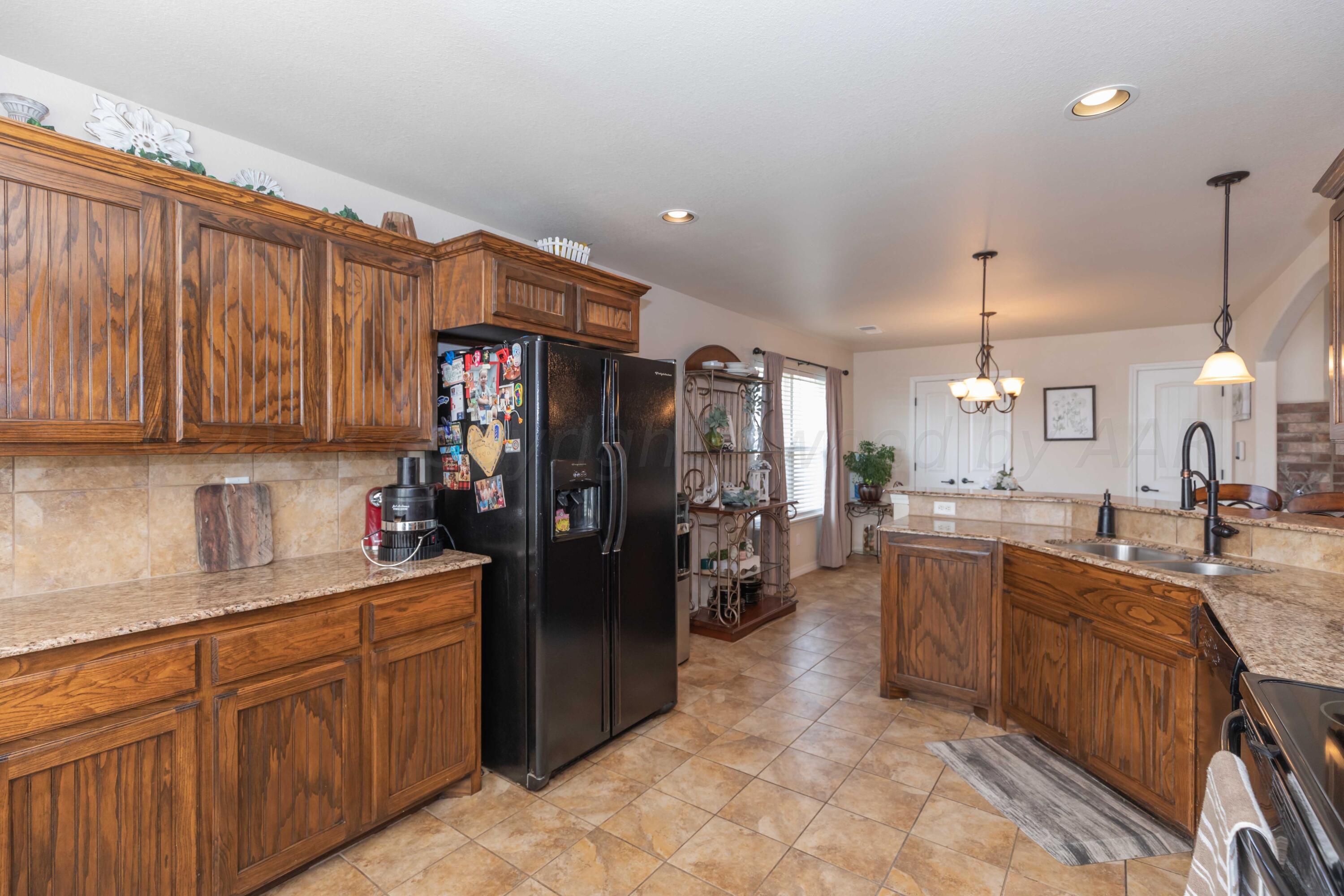 5904 South Rusk Street Amarillo, TX 79118 - Photo 15 of 49 a kitchen with refrigerator and cabinets