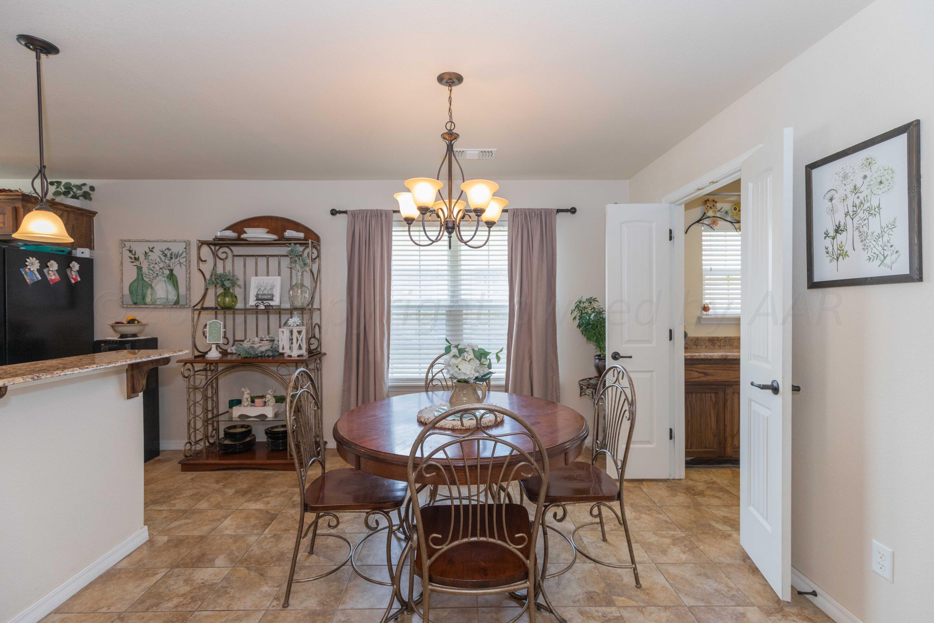 5904 South Rusk Street Amarillo, TX 79118 - Photo 17 of 49 a view of a dining room with furniture window and wooden floor