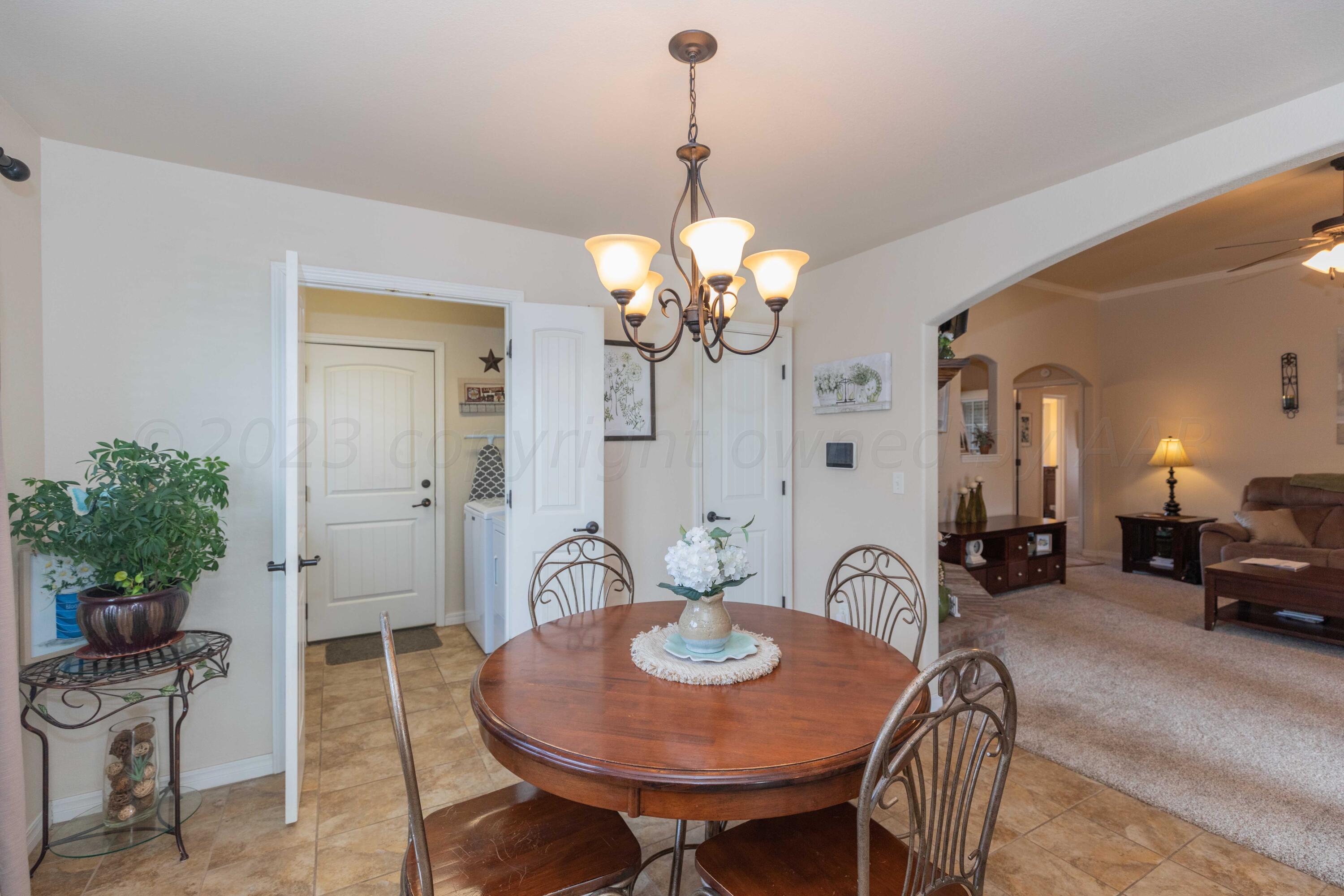 5904 South Rusk Street Amarillo, TX 79118 - Photo 19 of 49 a view of a dining room with furniture and chandelier