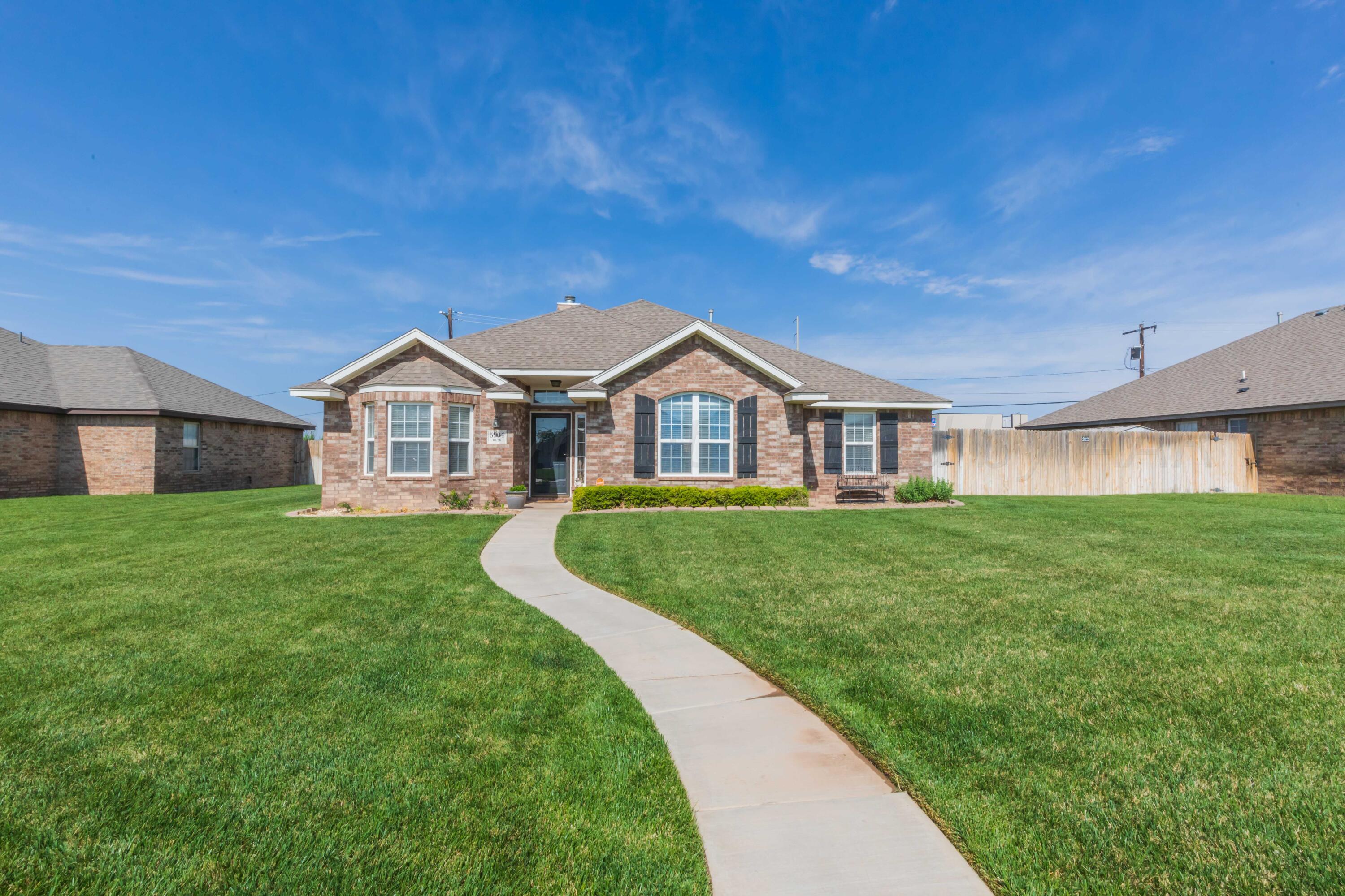 5904 South Rusk Street Amarillo, TX 79118 - Photo 2 of 49 a front view of a house with a yard and porch
