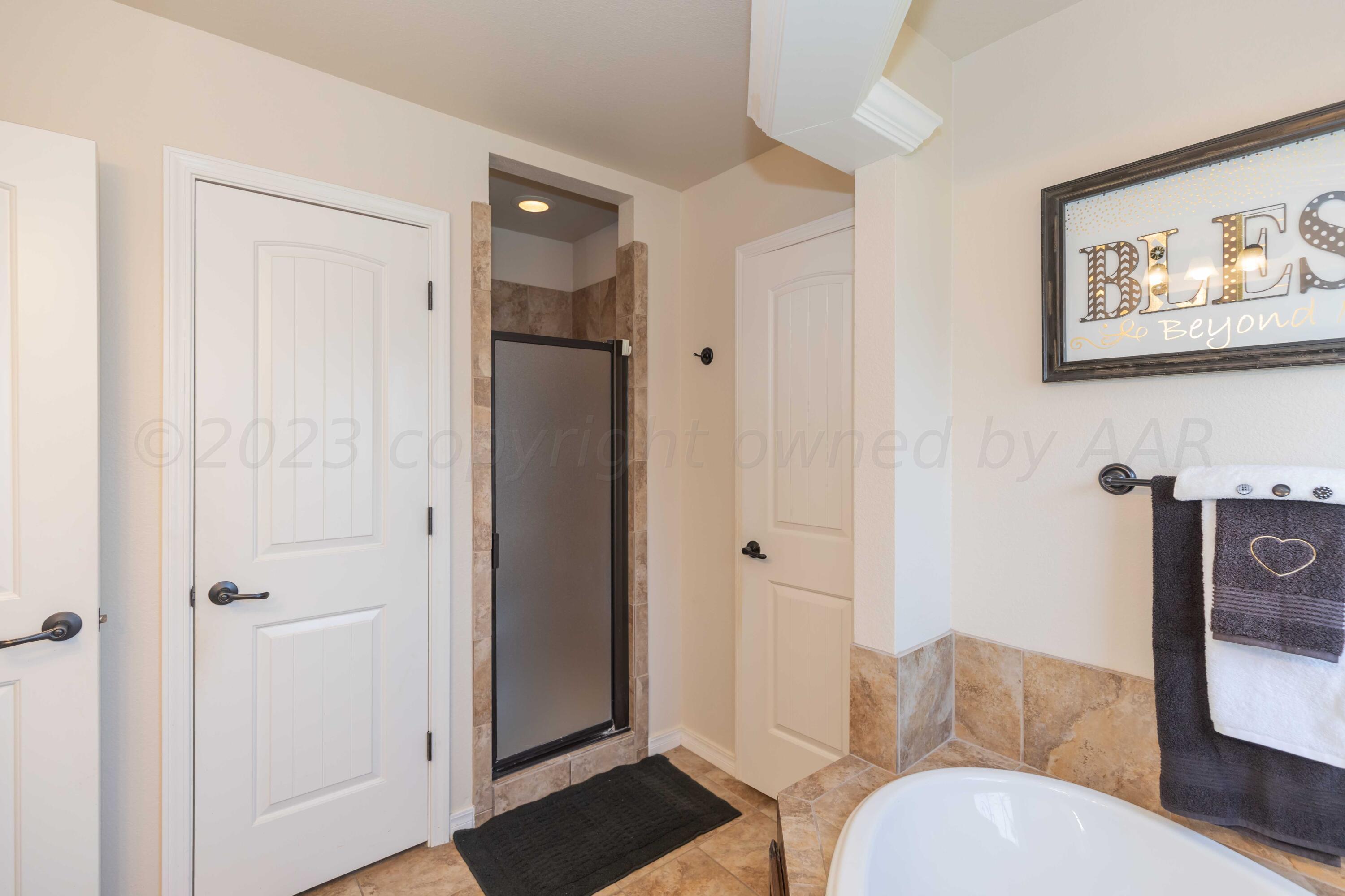 5904 South Rusk Street Amarillo, TX 79118 - Photo 26 of 49 a bathroom with a toilet tub and shower