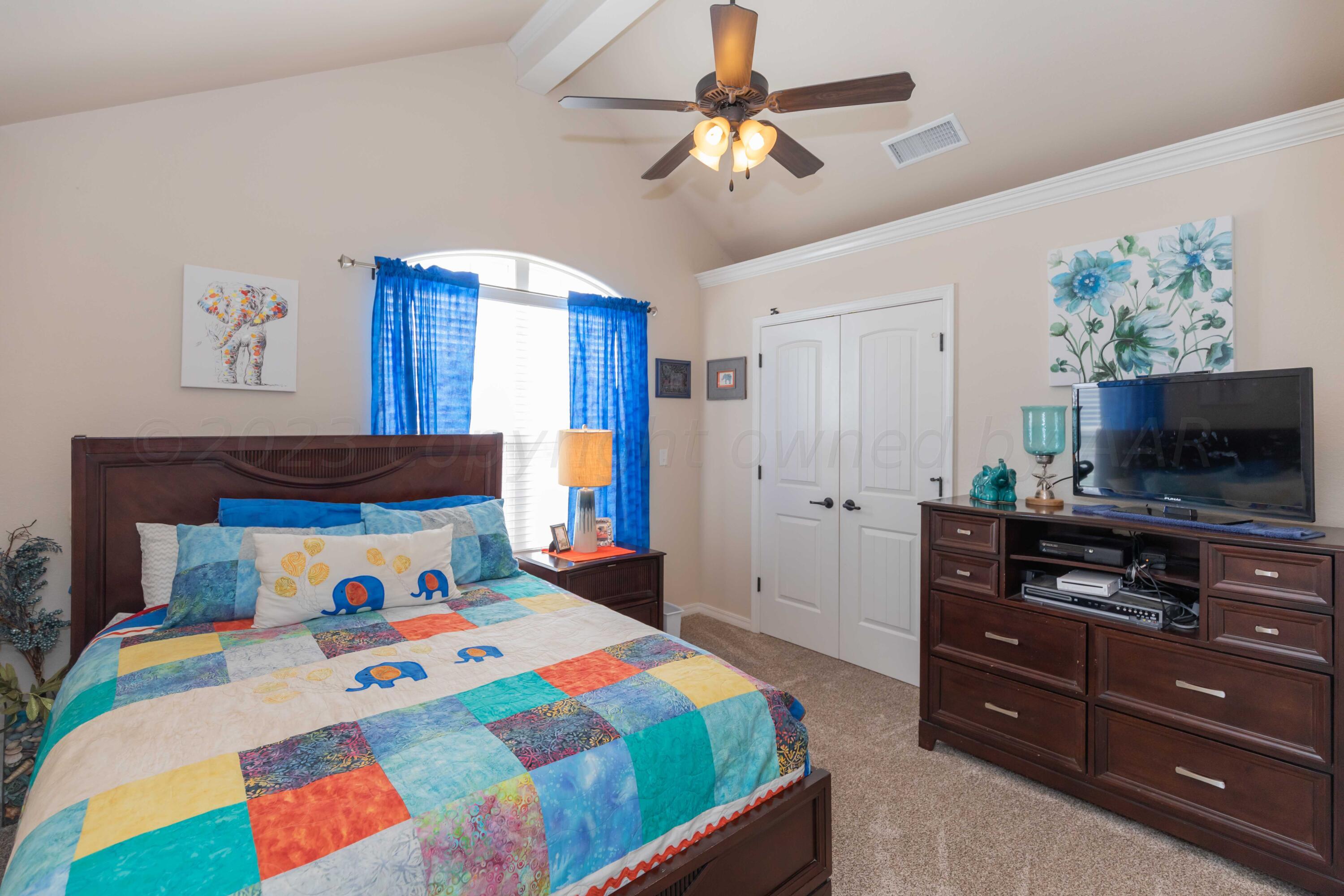 5904 South Rusk Street Amarillo, TX 79118 - Photo 29 of 49 a bedroom with a bed and a flat tv screen on dresser