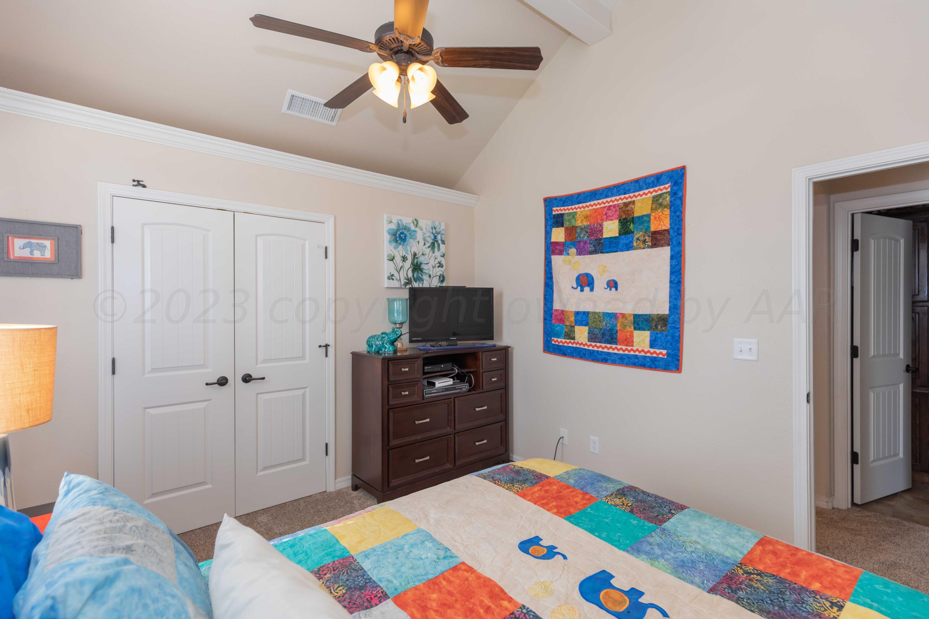 5904 South Rusk Street Amarillo, TX 79118 - Photo 30 of 49 a bedroom with a bed and a view of kitchen
