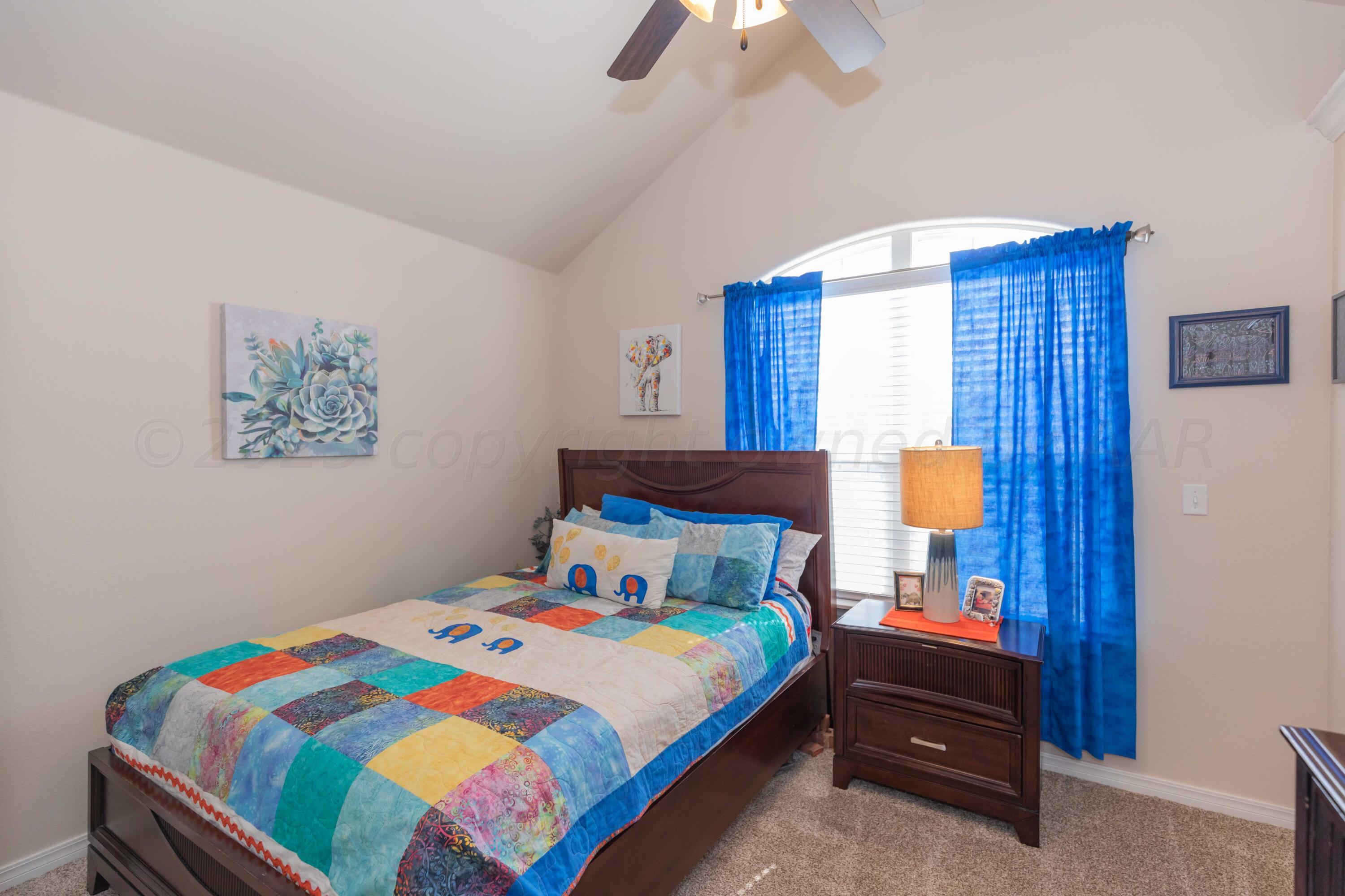 5904 South Rusk Street Amarillo, TX 79118 - Photo 32 of 49 a bedroom with a bed and a painting on the wall
