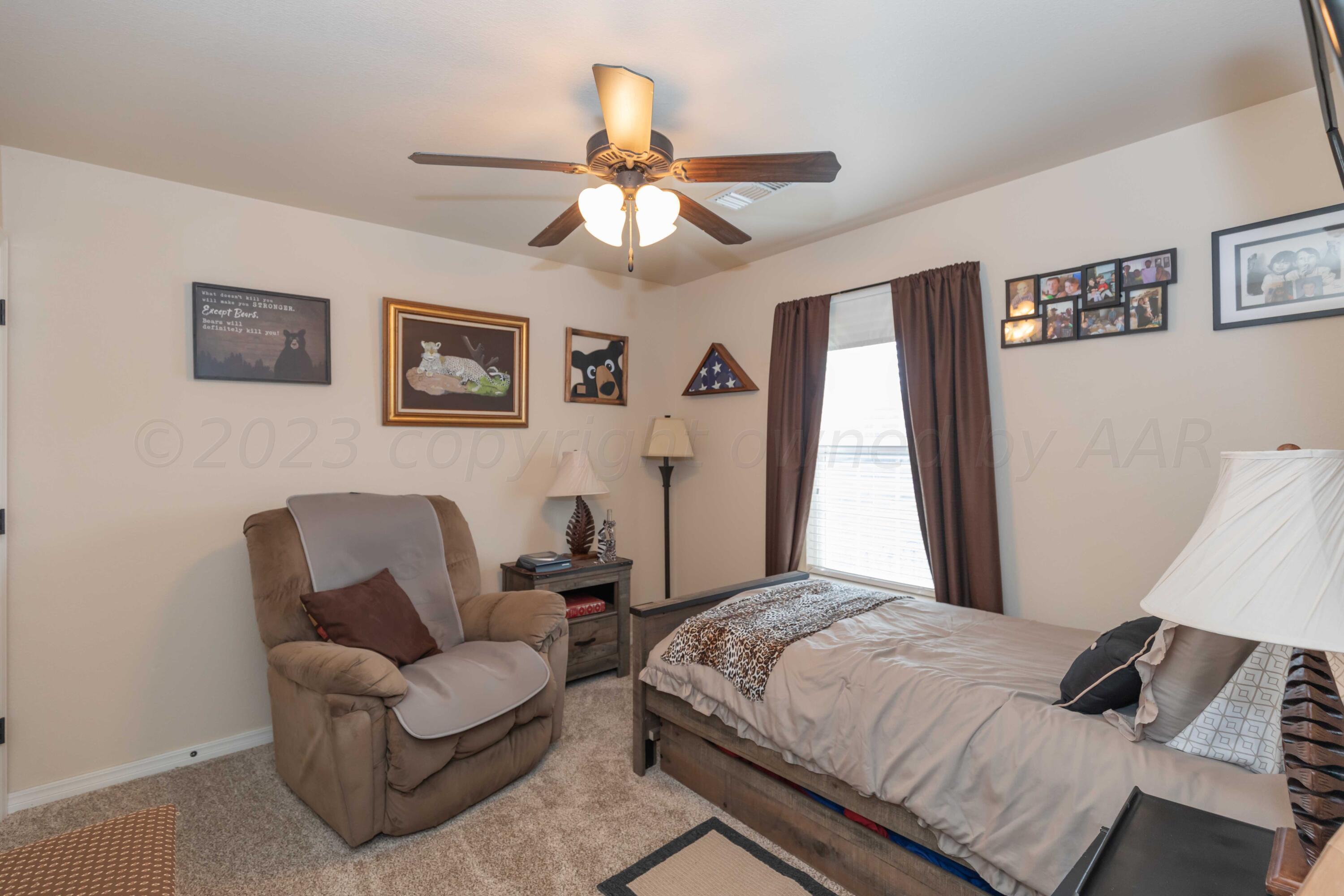 5904 South Rusk Street Amarillo, TX 79118 - Photo 35 of 49 a bedroom with a bed couch and window