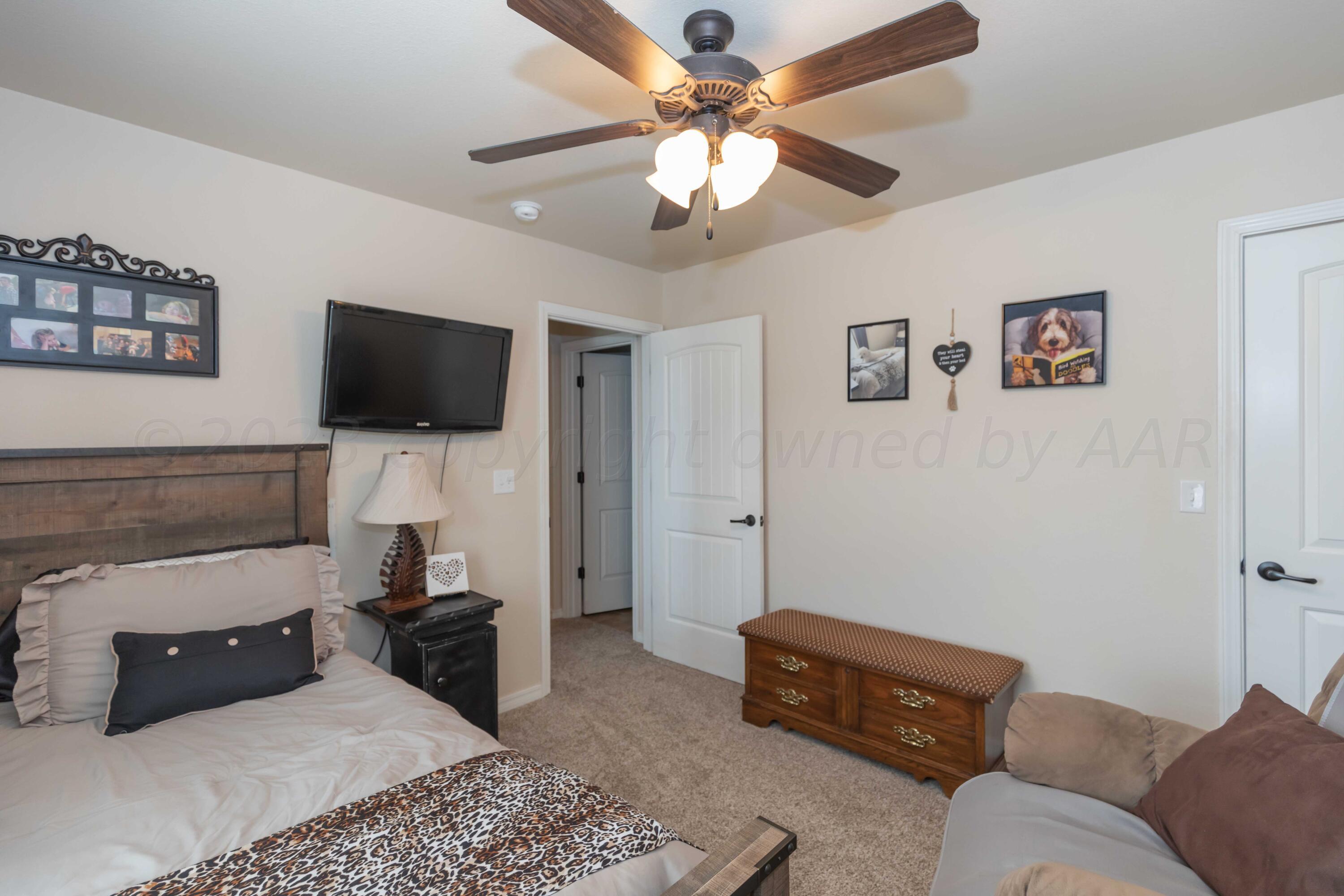 5904 South Rusk Street Amarillo, TX 79118 - Photo 37 of 49 a living room with furniture and a flat screen tv