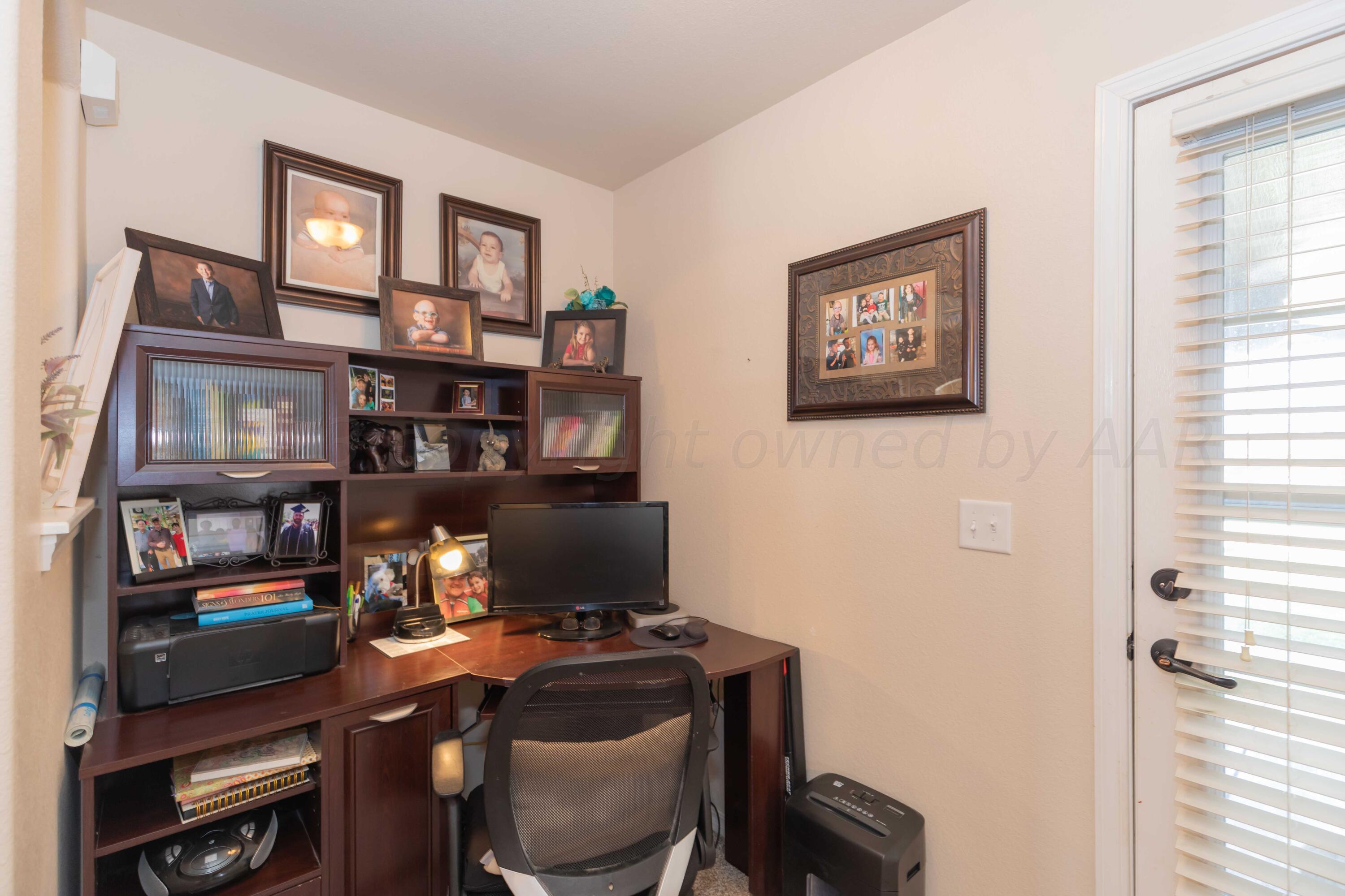 5904 South Rusk Street Amarillo, TX 79118 - Photo 38 of 49 a view of a workspace with furniture and a window