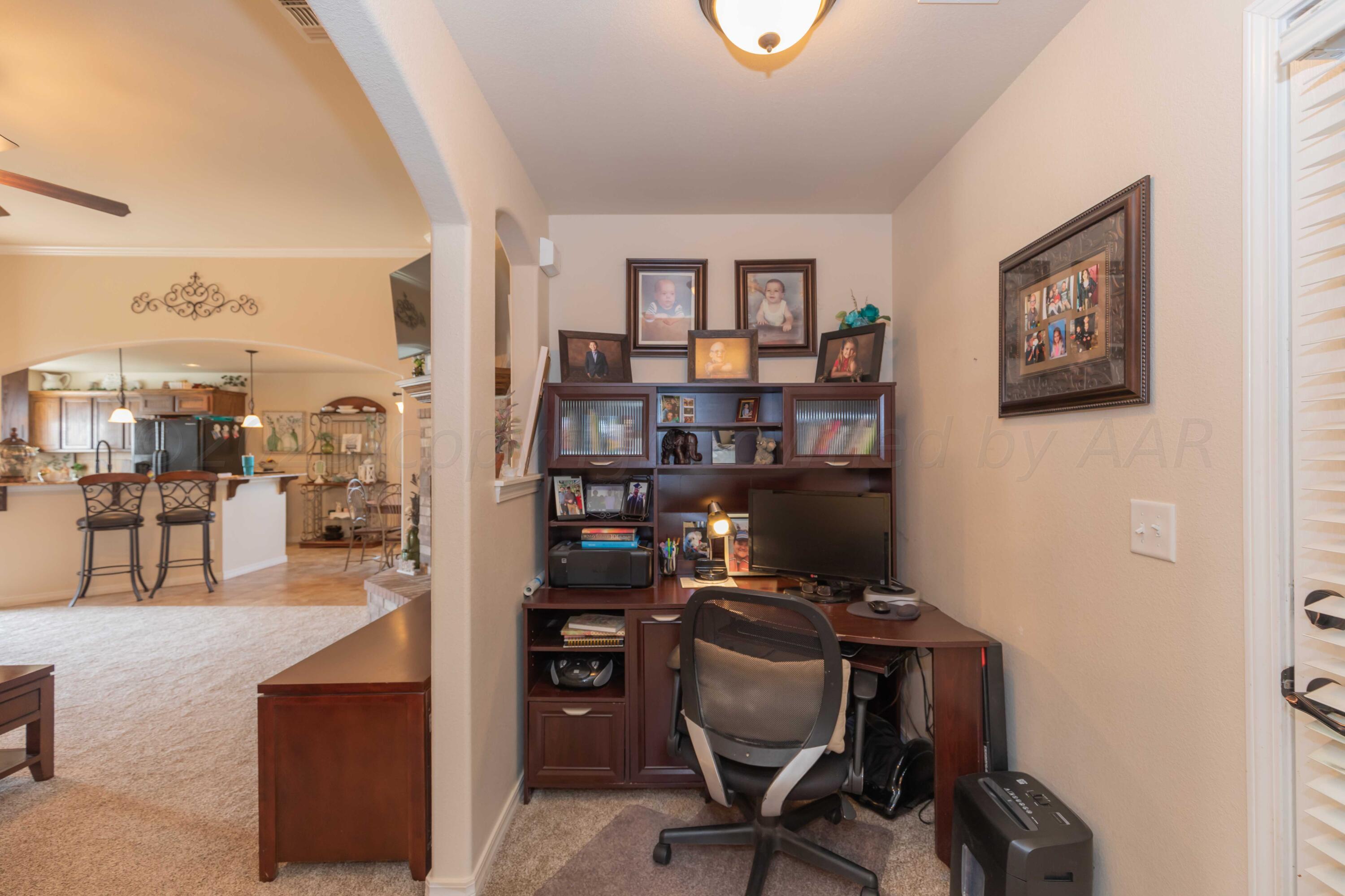 5904 South Rusk Street Amarillo, TX 79118 - Photo 39 of 49 a view of a workspace with a bookshelf