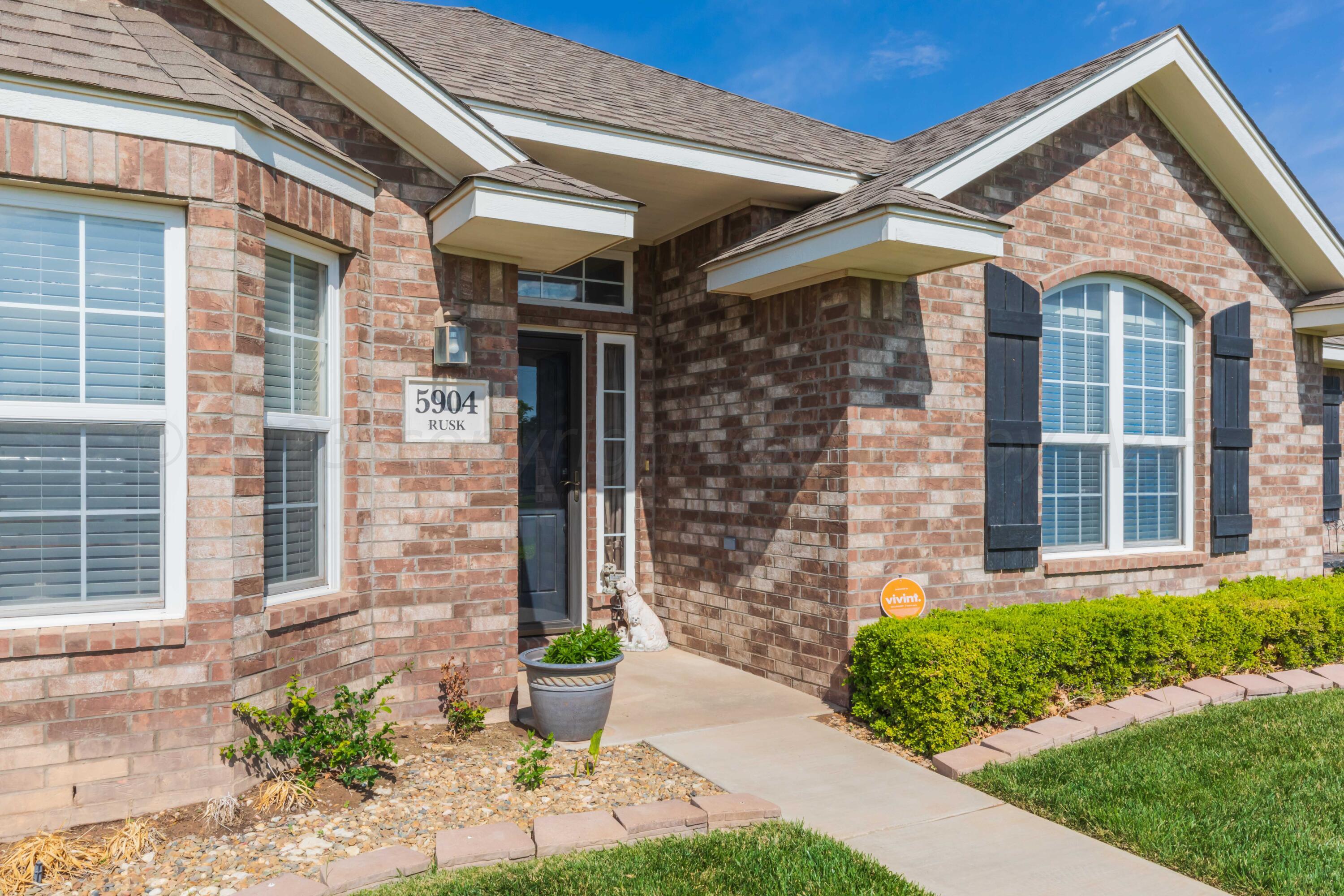 5904 South Rusk Street Amarillo, TX 79118 - Photo 5 of 49 a front view of a house with a garden