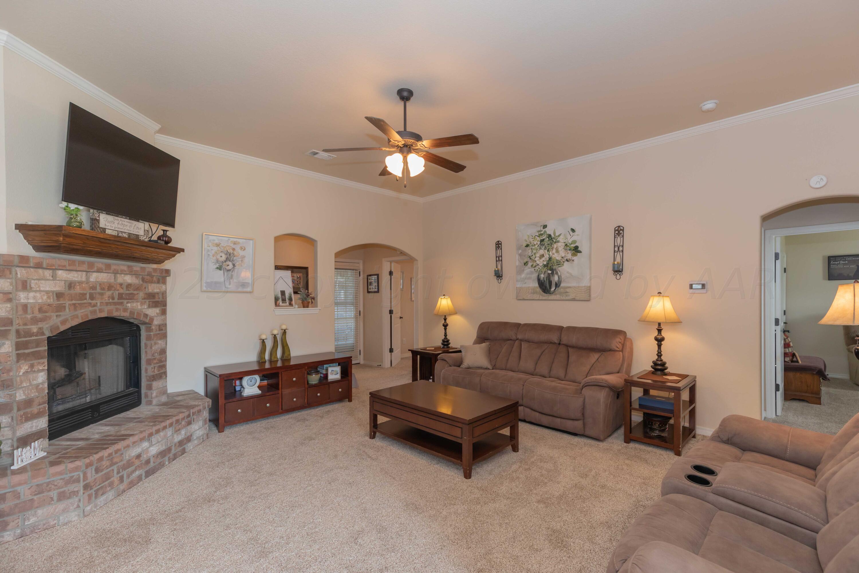 5904 South Rusk Street Amarillo, TX 79118 - Photo 6 of 49 a living room with furniture and a fireplace