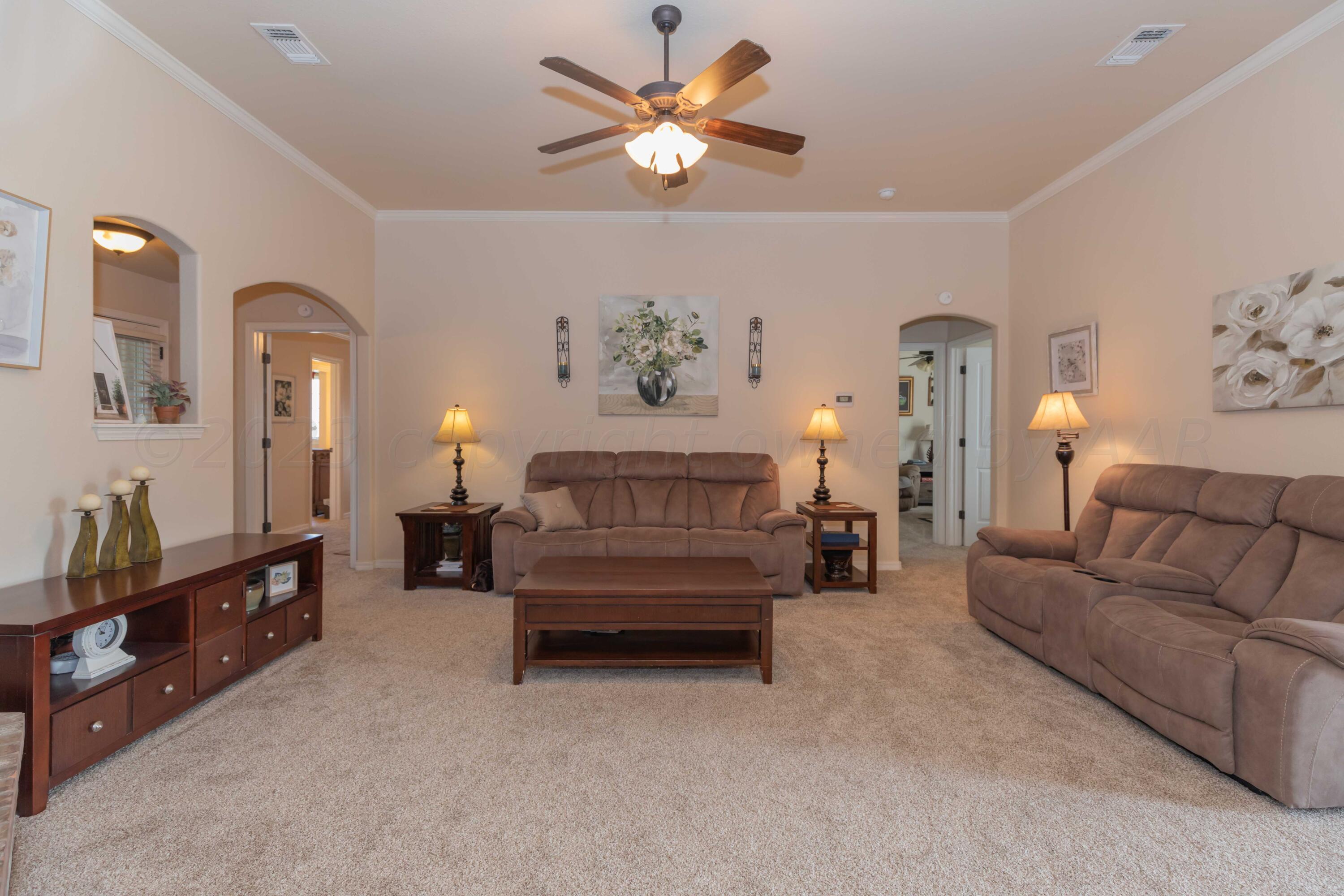 5904 South Rusk Street Amarillo, TX 79118 - Photo 7 of 49 a living room with furniture and a chandelier