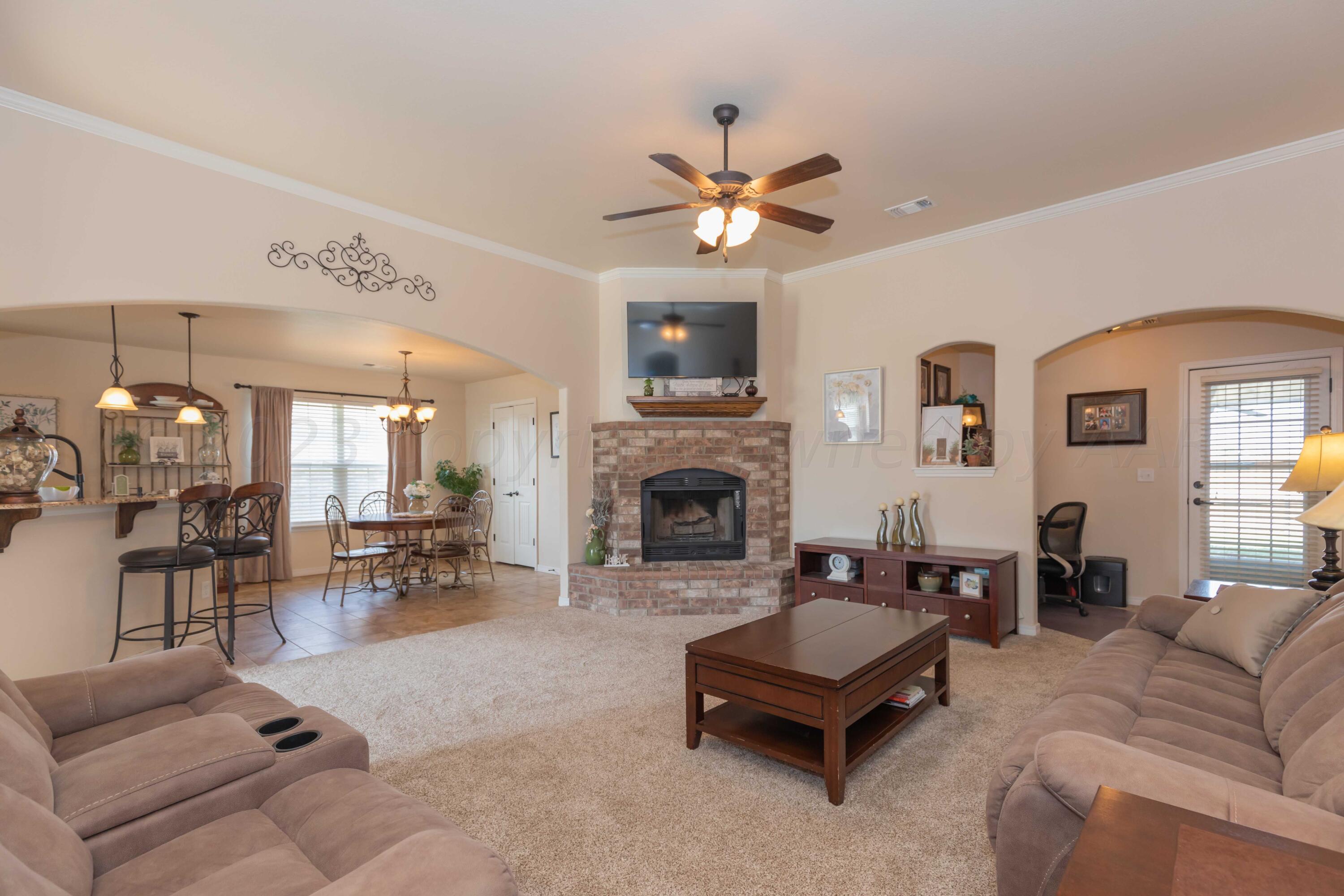 5904 South Rusk Street Amarillo, TX 79118 - Photo 8 of 49 a living room with furniture and a fireplace