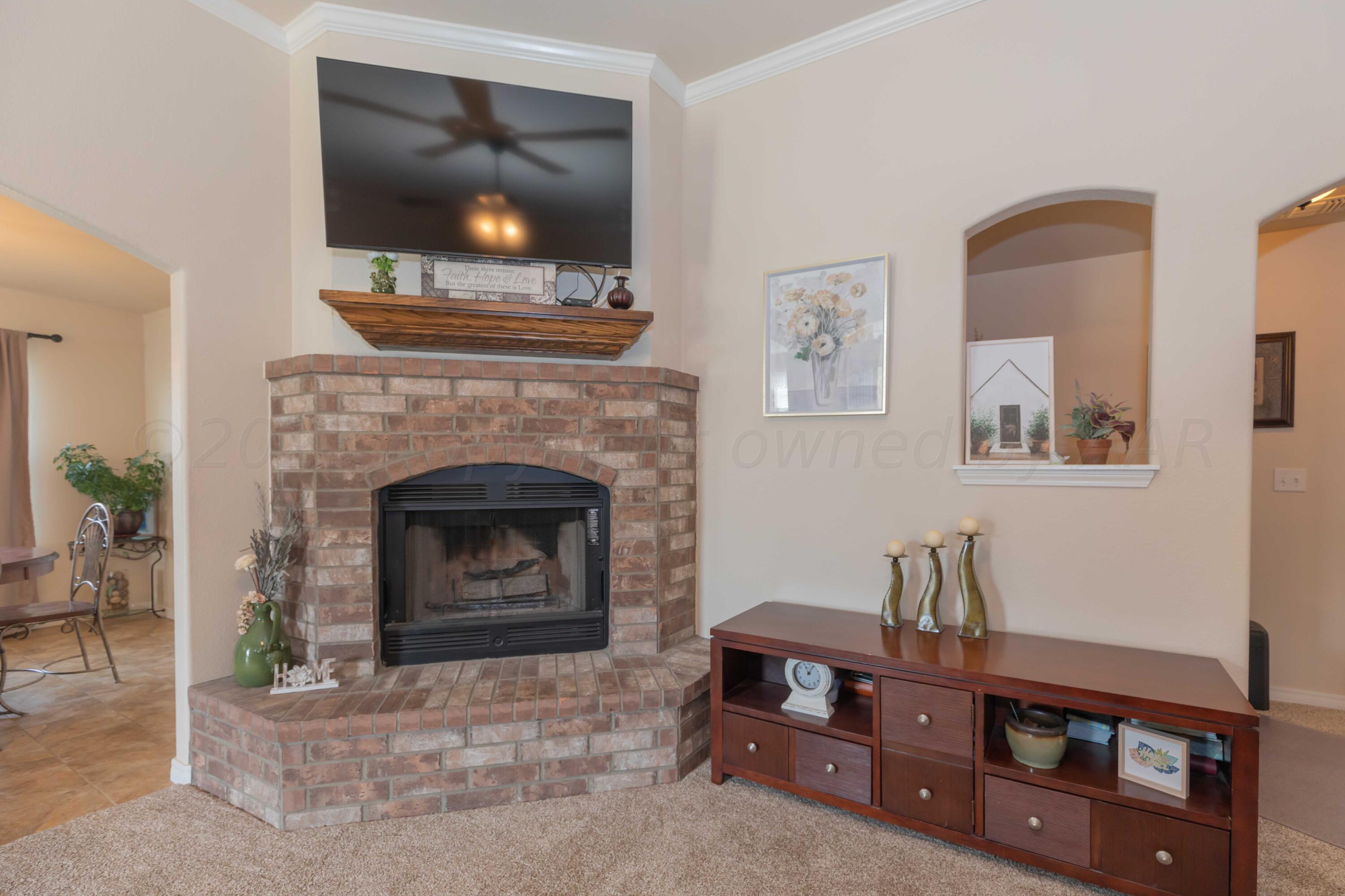 5904 South Rusk Street Amarillo, TX 79118 - Photo 9 of 49 a living room with furniture and a fireplace