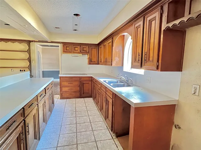 a kitchen with stainless steel appliances a sink stove and cabinets