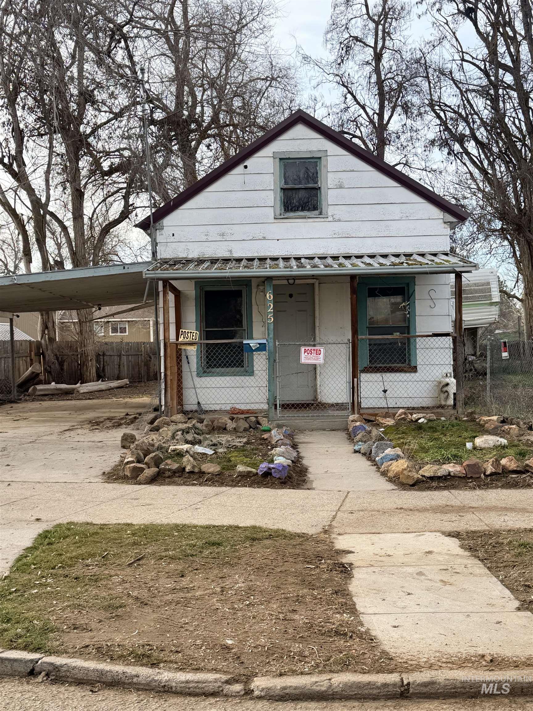 View of front of house featuring a carport, covered porch, and concrete driveway