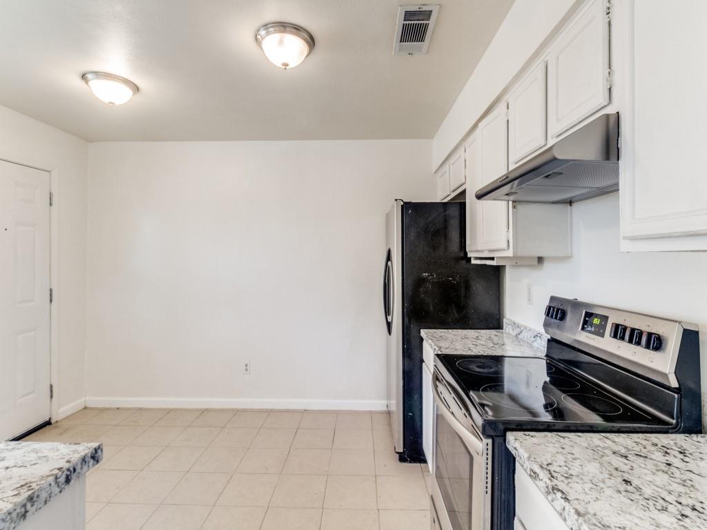 2321 Colonial Mesquite, TX 75150 - Photo 11 of 25 a kitchen with stainless steel appliances a stove a refrigerator and cabinets