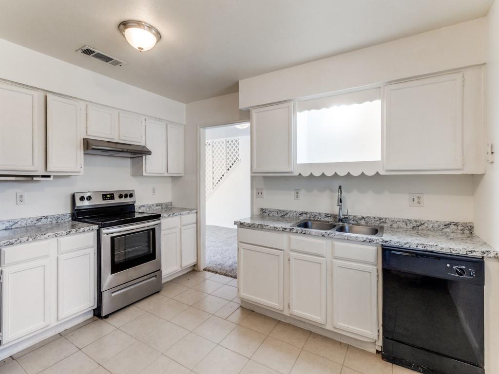 2321 Colonial Mesquite, TX 75150 - Photo 12 of 25 a kitchen with stainless steel appliances granite countertop white cabinets granite counter tops and a stove