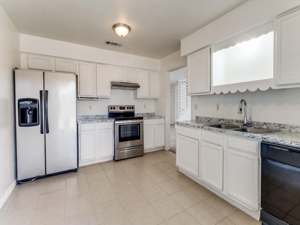 2321 Colonial Mesquite, TX 75150 - Photo 13 of 25 a kitchen with stainless steel appliances granite countertop a refrigerator sink and stove