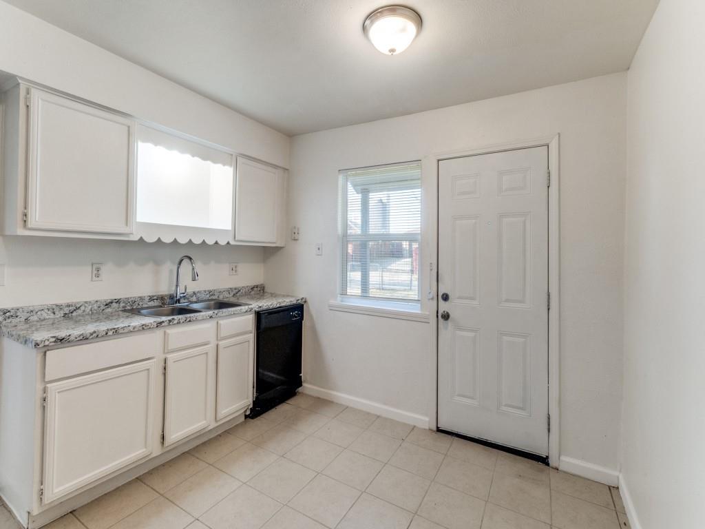2321 Colonial Mesquite, TX 75150 - Photo 14 of 25 a kitchen with granite countertop white cabinets and white appliances