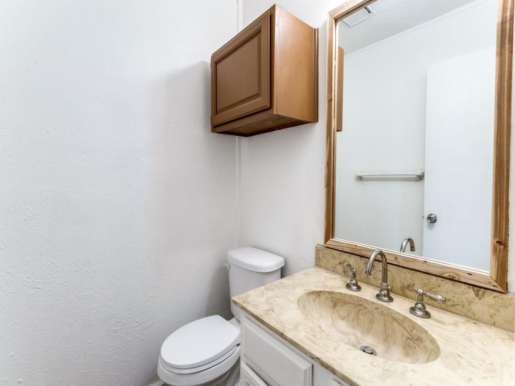 2321 Colonial Mesquite, TX 75150 - Photo 17 of 25 a bathroom with a granite countertop toilet sink and mirror