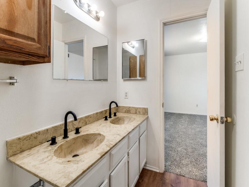 2321 Colonial Mesquite, TX 75150 - Photo 21 of 25 a bathroom with a sink and a mirror