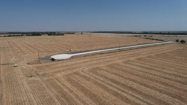 a view of a water fountain with wooden fence