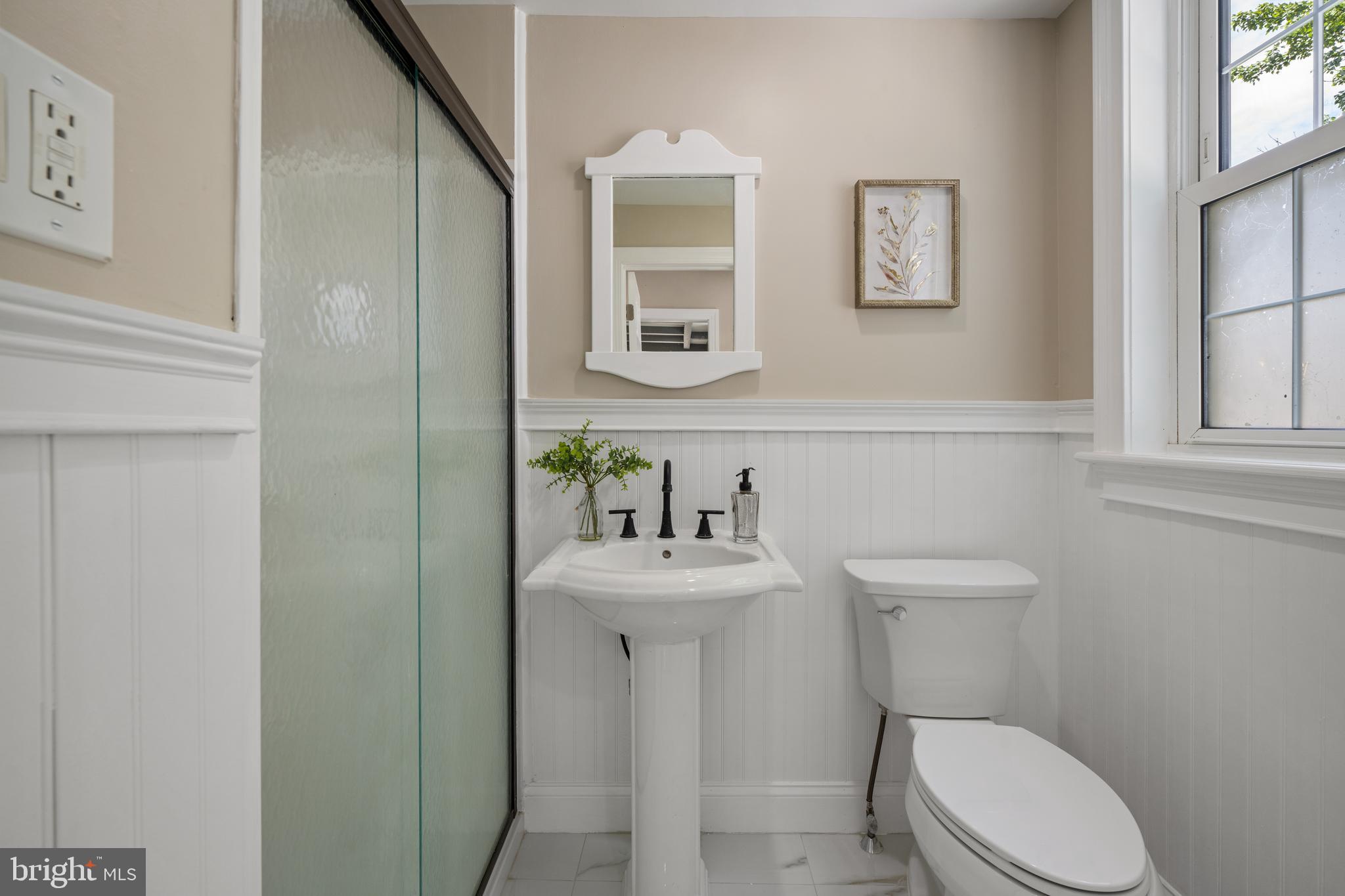 15 Lafayette Road Audubon, NJ 08106 - Photo 29 of 50 a bathroom with a sink mirror toilet and a window
