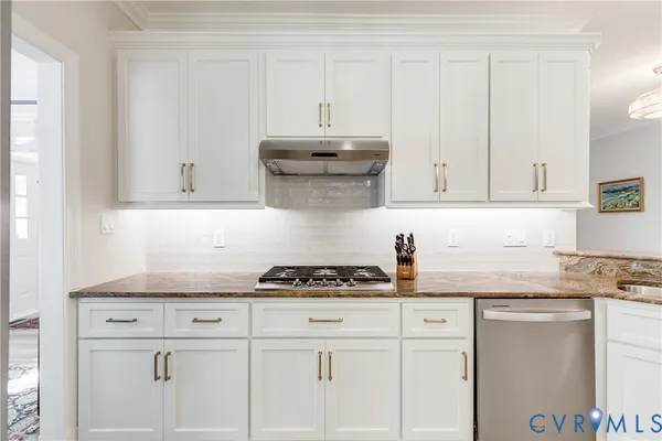 a kitchen with granite countertop a stove a sink and a granite counter tops