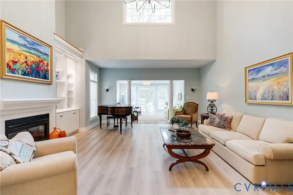 a living room with furniture fireplace and window