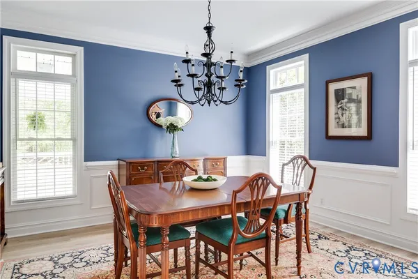 a view of a dining room with furniture and chandelier