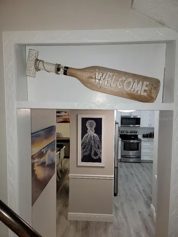 a bedroom with a bed and a flat tv screen on dresser