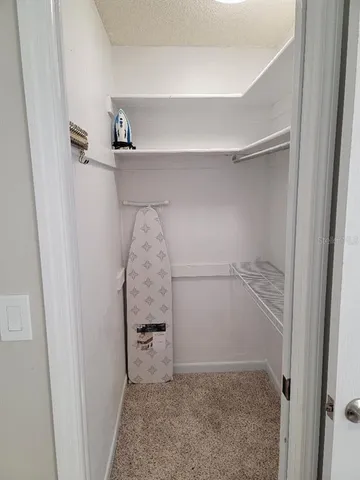 a bathroom with a granite countertop sink toilet and mirror