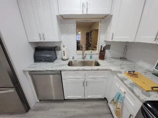 a kitchen with a sink stove and cabinets