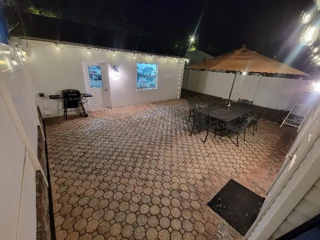 a backyard of a house with table and chairs