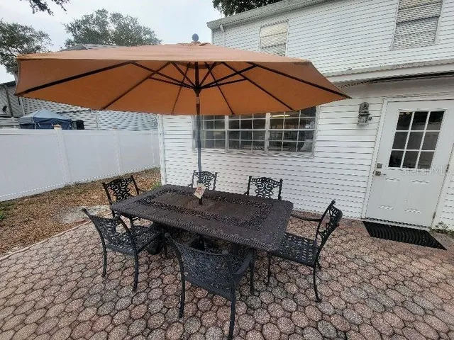 a kitchen with a stove and a wooden floor