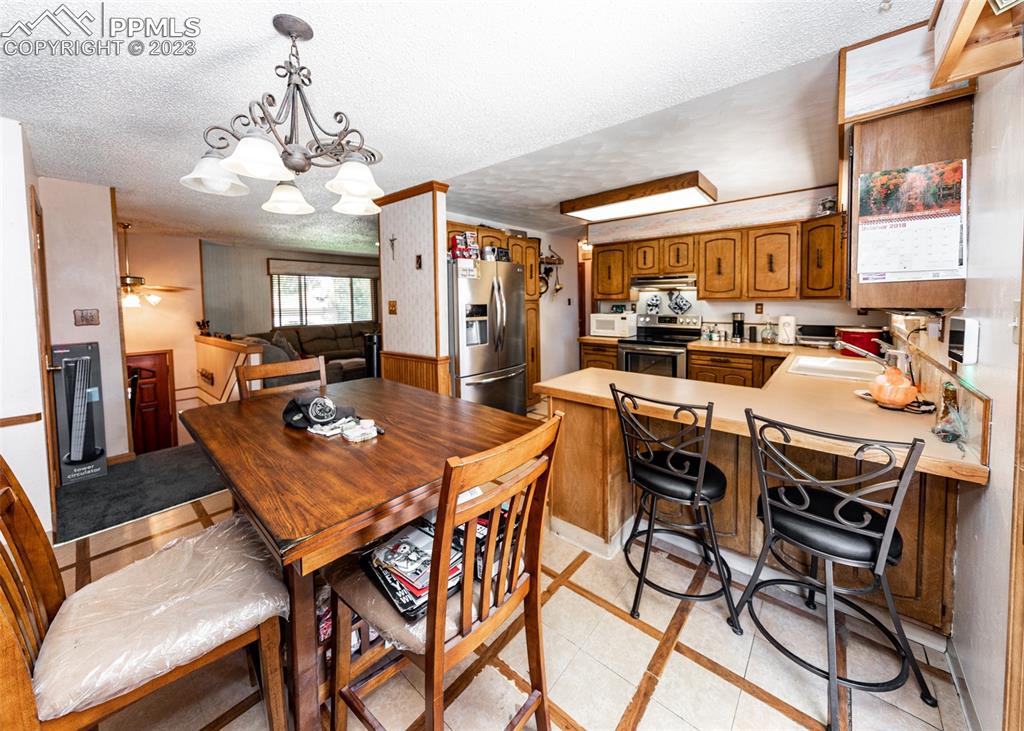 126 La Rochelle Drive Pueblo, CO 81005 - Photo 12 of 42 a view of a dining room with furniture window and wooden floor