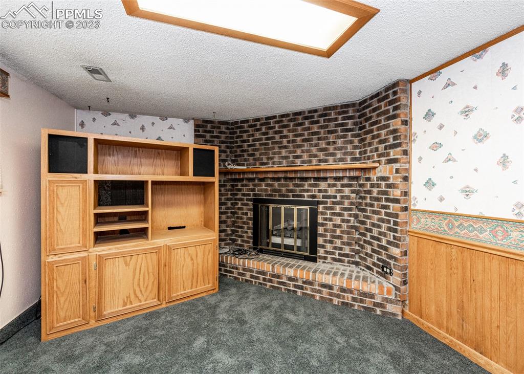 126 La Rochelle Drive Pueblo, CO 81005 - Photo 23 of 42 a living room with a fireplace