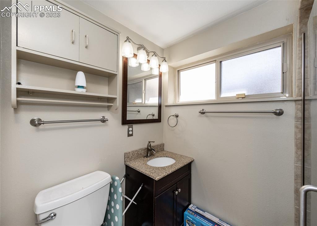 126 La Rochelle Drive Pueblo, CO 81005 - Photo 29 of 42 a bathroom with a sink a toilet a window and mirror