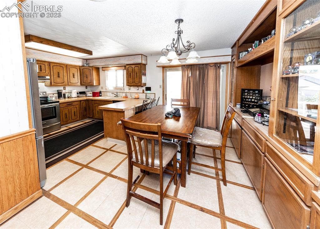 126 La Rochelle Drive Pueblo, CO 81005 - Photo 6 of 42 a view of a dining room with furniture a chandelier and kitchen view