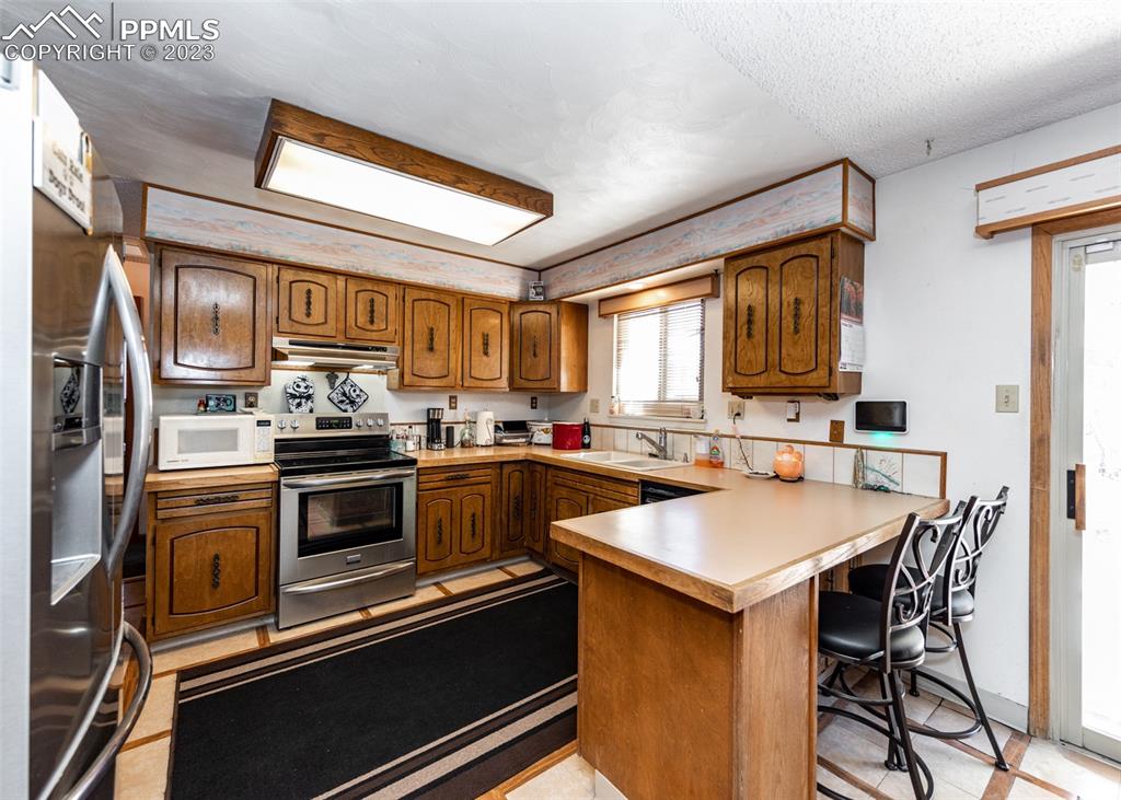126 La Rochelle Drive Pueblo, CO 81005 - Photo 9 of 42 a kitchen with a sink cabinets and stainless steel appliances