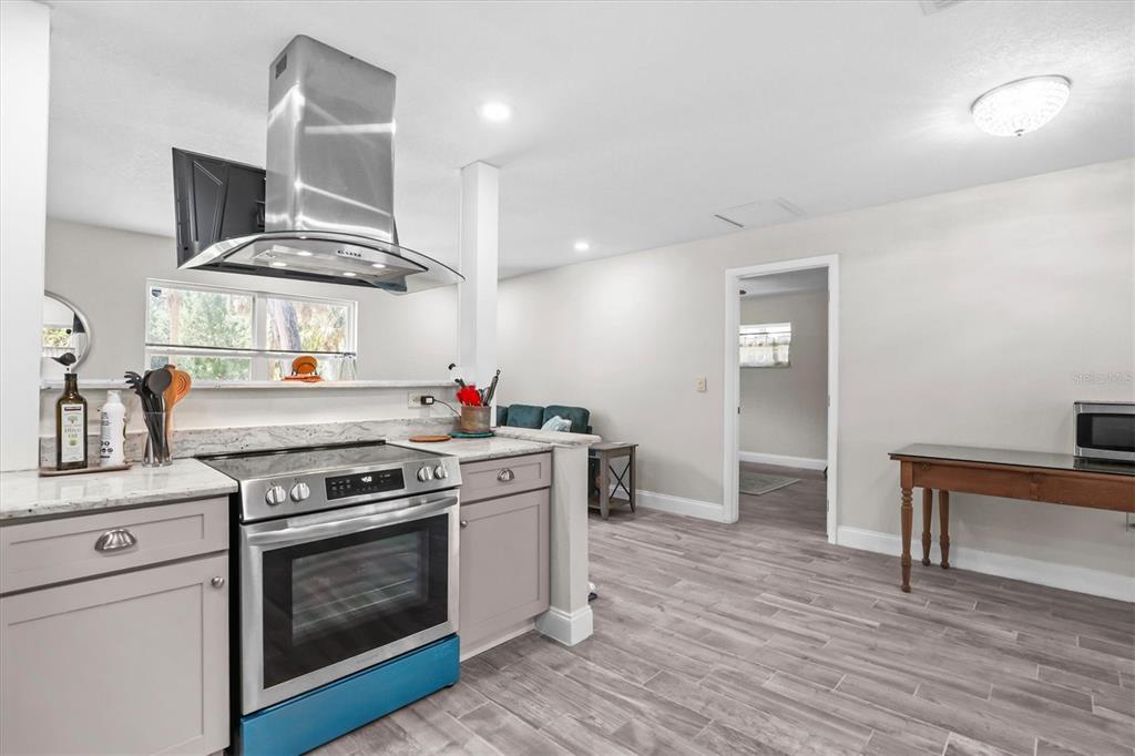 6244 Colony Circle Weeki Wachee, FL 34607 - Photo 43 of 60 a kitchen with a stove and wooden floor